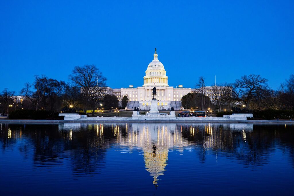 US Capitol Building and Rotunda illuminated at twilight against a blue sky in Washington DC